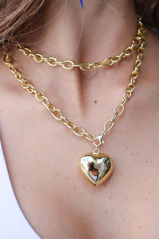 Layered heart necklace on model.
