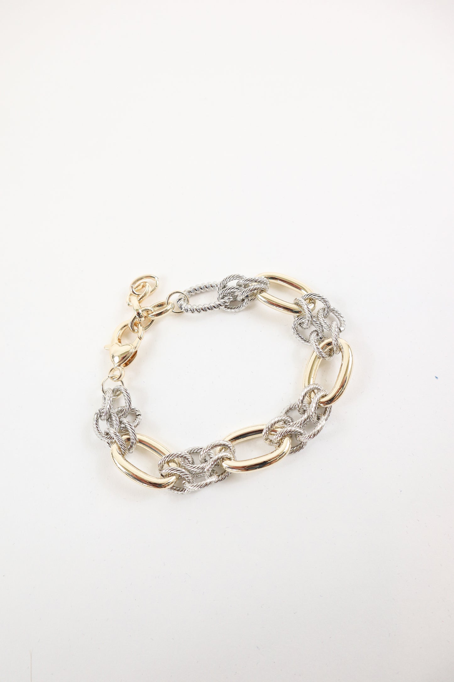 Mixed metal gold and silver chunky chain bracelet with oversized oval links, women’s boutique statement jewelry.