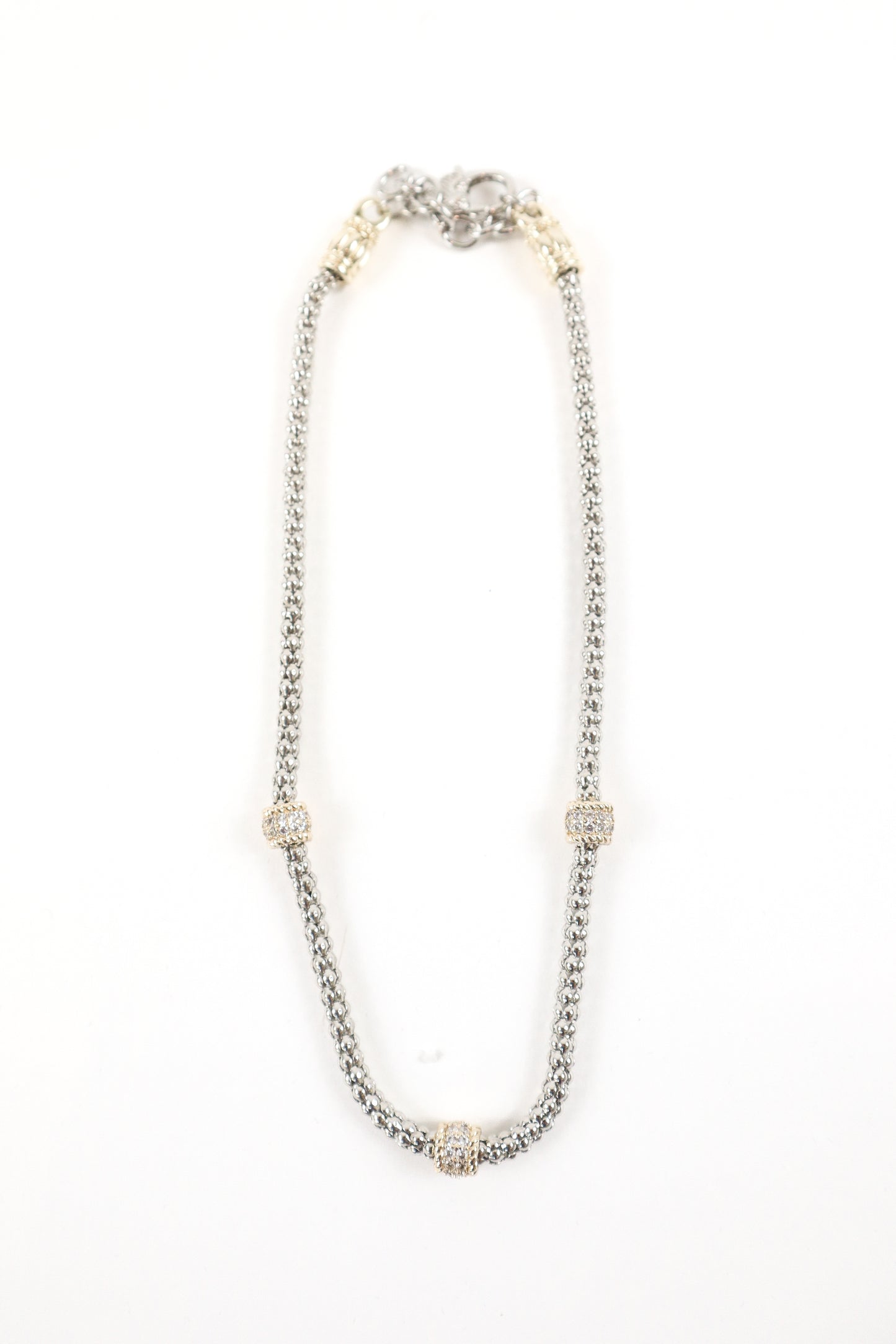 Silver chain necklace with gold pavé accent stations, women’s boutique mixed metal statement jewelry.