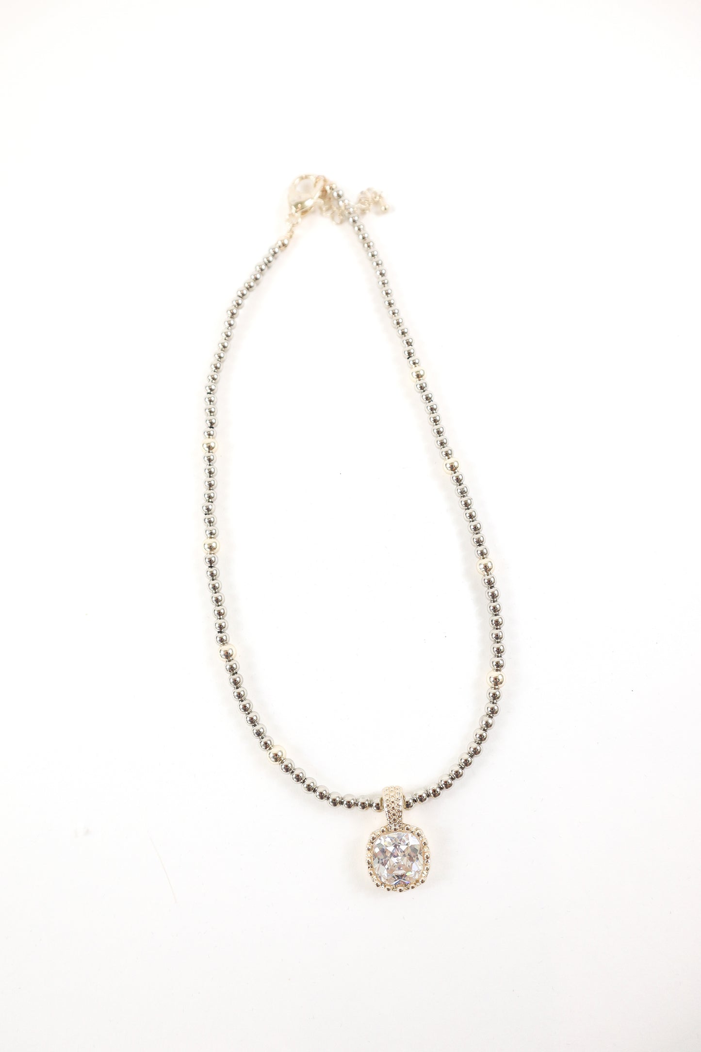Silver beaded necklace with cushion-cut crystal pendant and pavé detailing, women’s boutique statement jewelry.