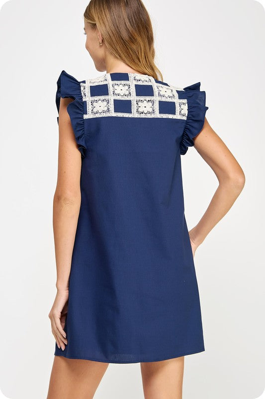linen mini dress with crochet yoke detailing, flutter sleeves, and side pockets