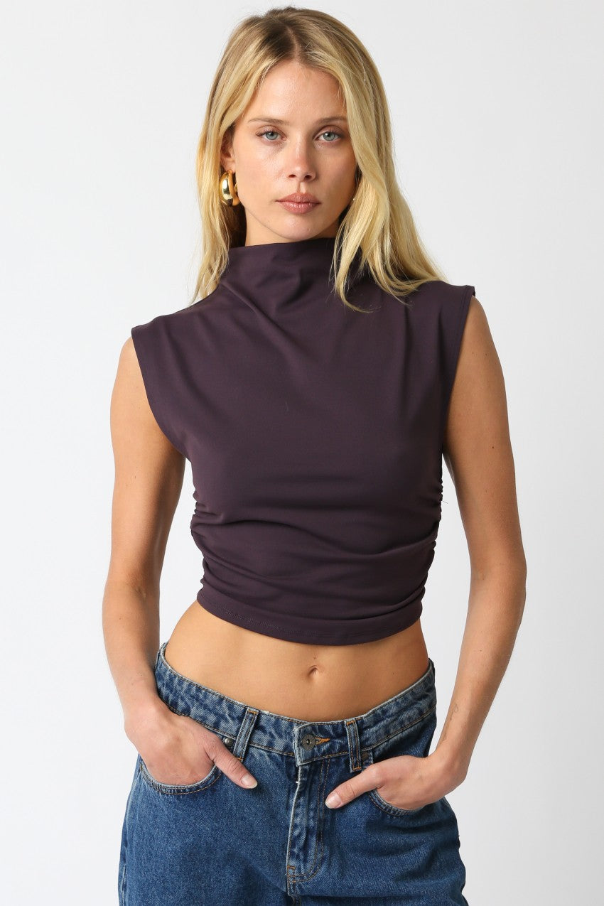 The Sarah Cropped Top features a classic turtleneck and a modern cropped fit, blending timeless style with a contemporary edge.