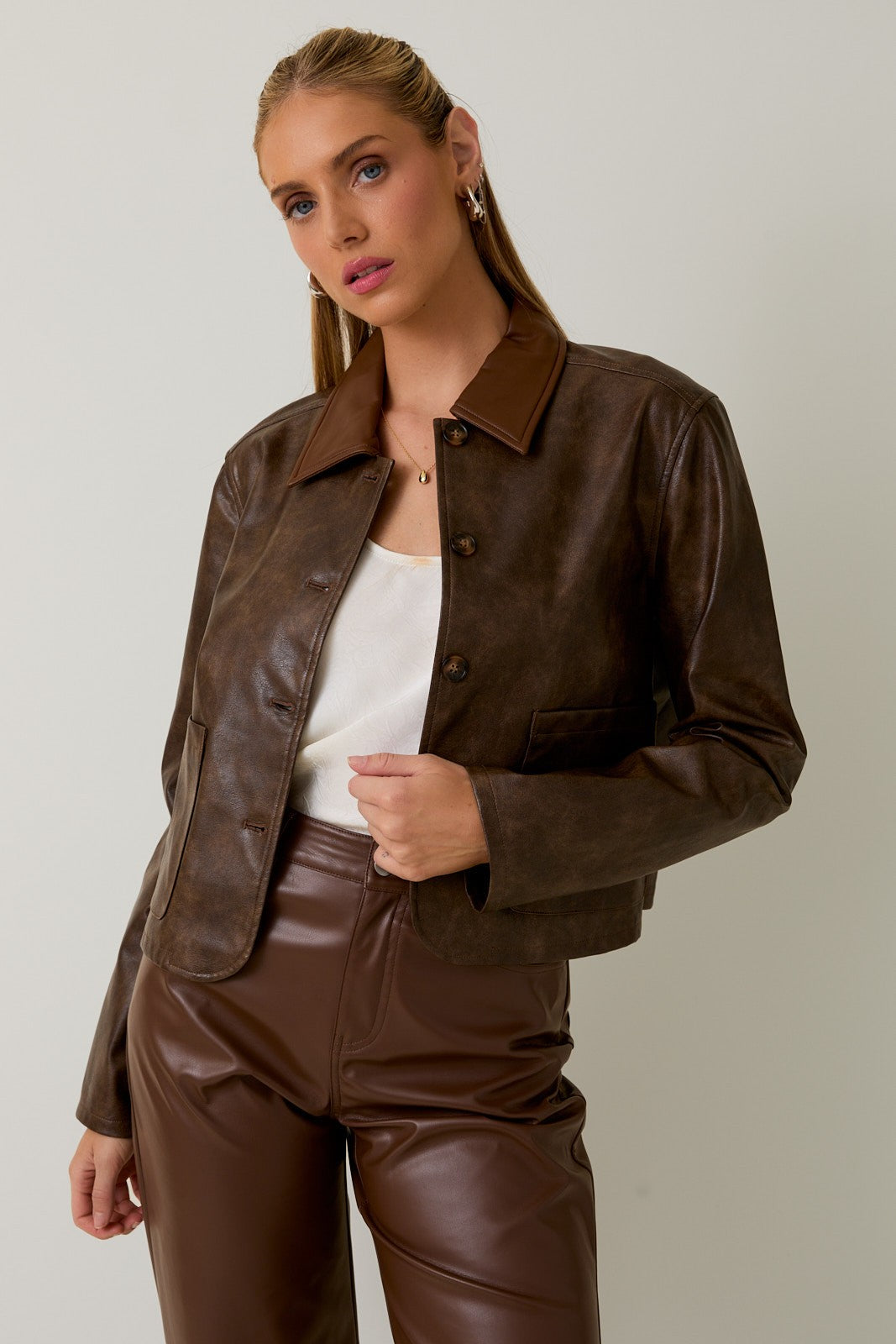 Edgy and elevated, the Vera cropped jacket pairs sleek faux leather with a modern, boxy silhouette.
