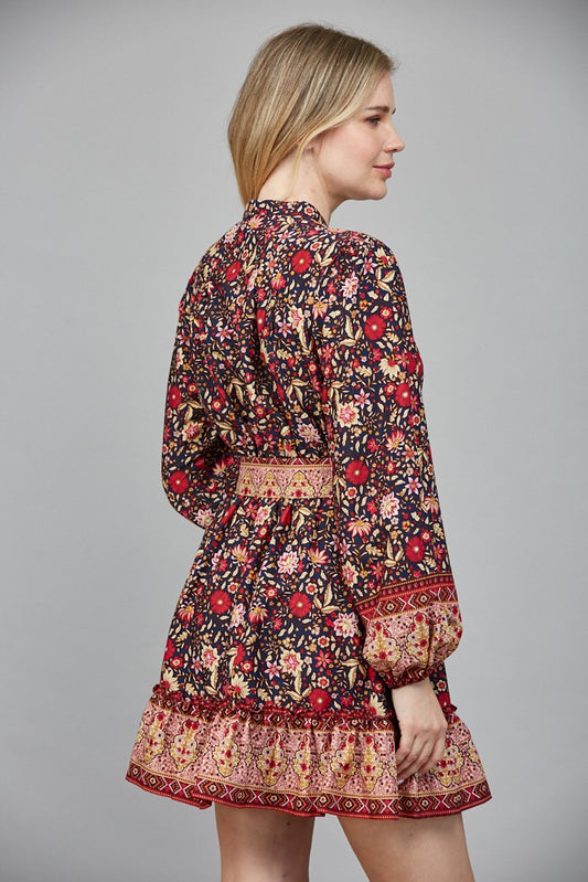 Chic and flattering, the Delphine dress features a striking border print and a belted button-down silhouette.