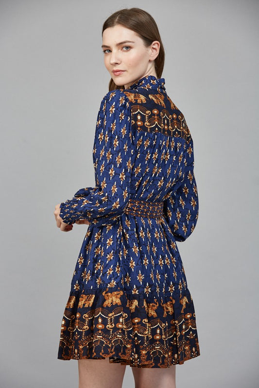 The Isla mini dress stuns with a high neck collar band, delicate ruffles, and an effortlessly feminine silhouette.