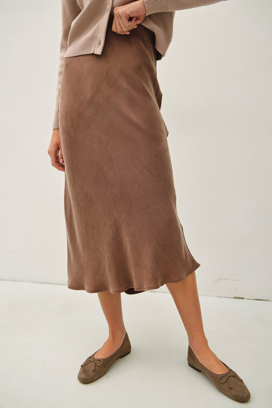 Soft, flowy, and flattering—the Rowena midi skirt brings luxe texture to an everyday silhouette.