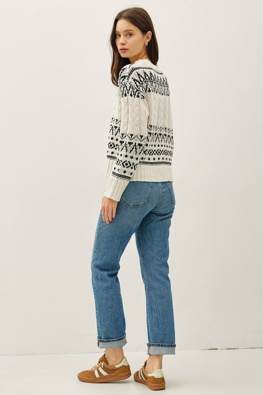 A cozy Fair Isle sweater with cable knit texture and a relaxed, oversized fit — the perfect blend of comfort and charm.