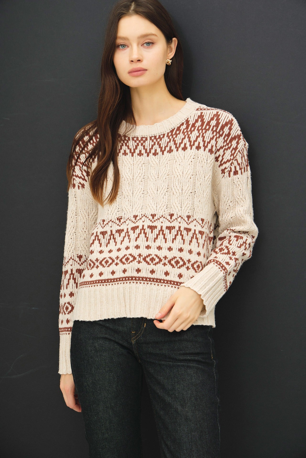 A cozy Fair Isle sweater with cable knit texture and a relaxed, oversized fit — the perfect blend of comfort and charm.
