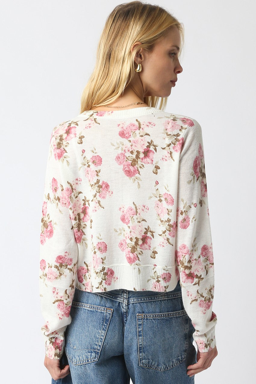 Cropped floral knit cardigan with vintage flower pattern, button front, and ribbed hem.