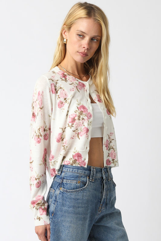 Cropped floral knit cardigan with vintage flower pattern, button front, and ribbed hem.