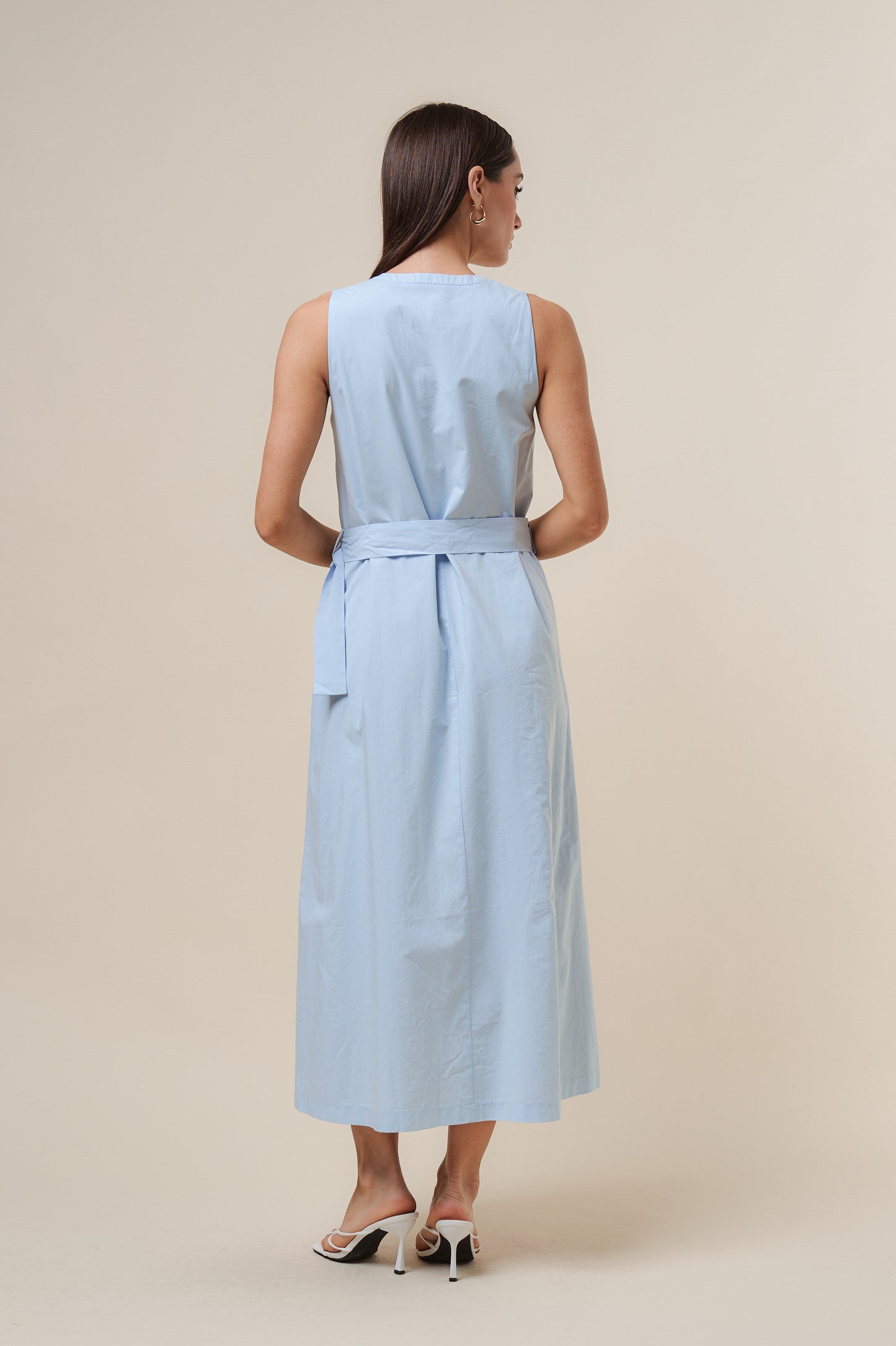 D-Ring Maxi Dress features a sleeveless silhouette with a self-tie belt, gold metal D-ring, and button details