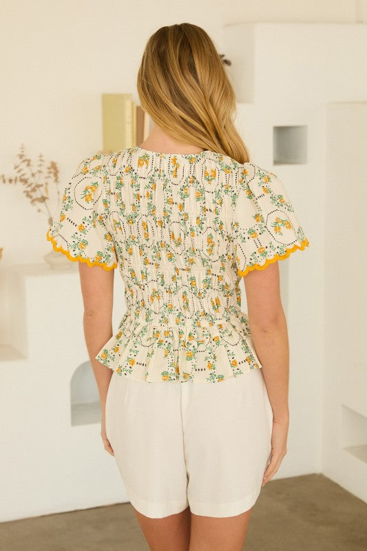 Floral Peplum Top features a flattering V-neckline, puff sleeves, and a waist-defining silhouette