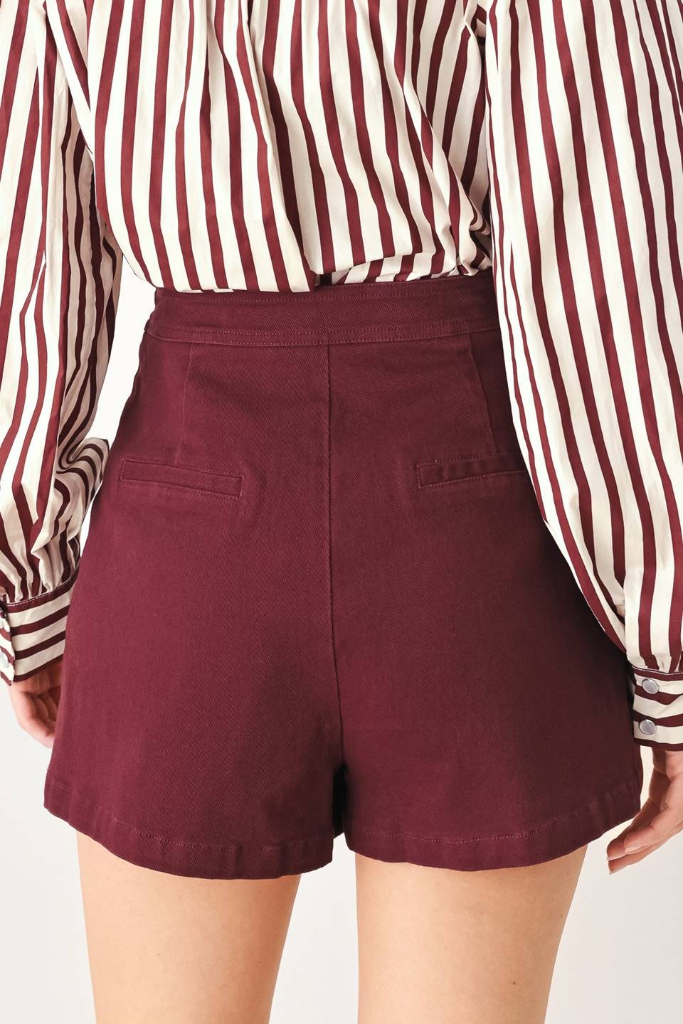 Tailored woven skort featuring a front closure, button detailing, and a flattering silhouette with built-in shorts for comfortable everyday wear.