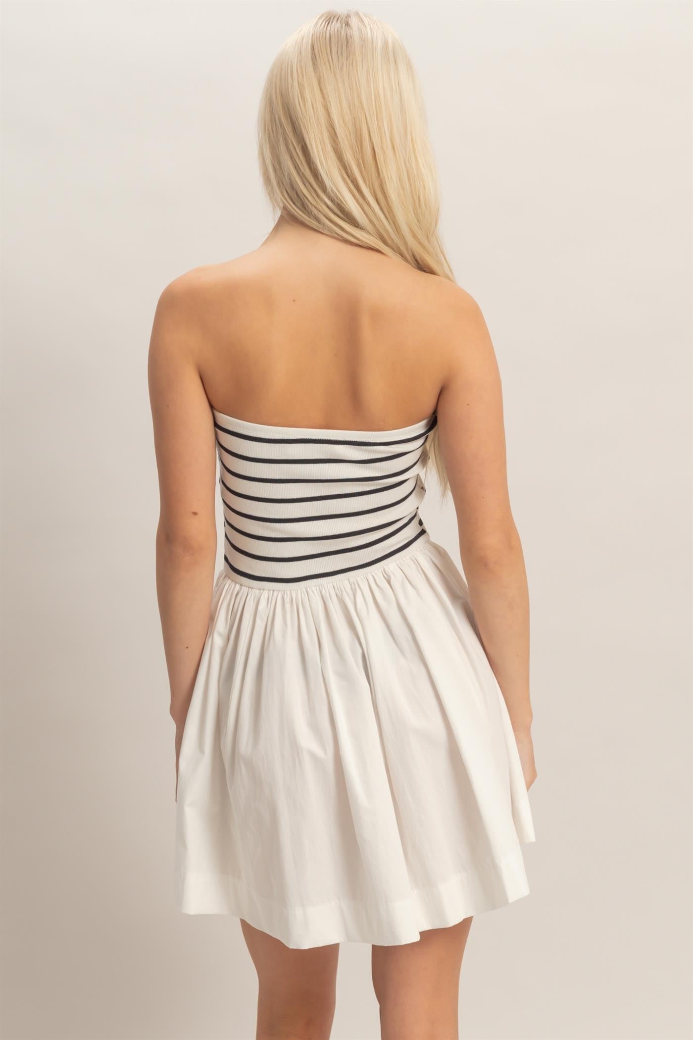 strapless striped mini dress featuring a fitted knit bodice and flowy woven skirt