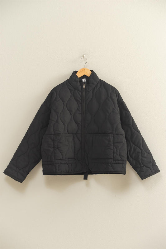 The Evadne Quilted Drawstring Jacket delivers cozy structure with a modern relaxed fit.