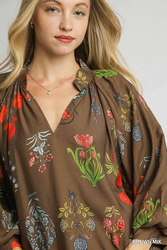 A feminine floral blouse with scalloped details and an easy, relaxed fit—perfect for effortless elegance.