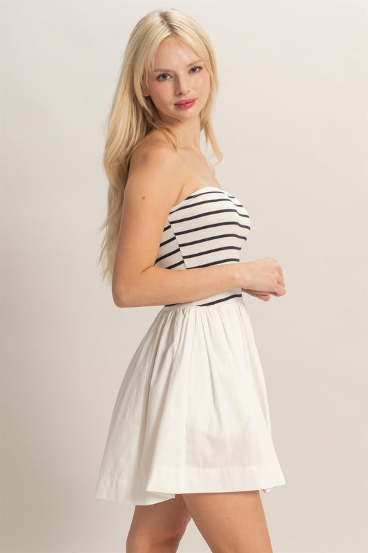 strapless striped mini dress featuring a fitted knit bodice and flowy woven skirt
