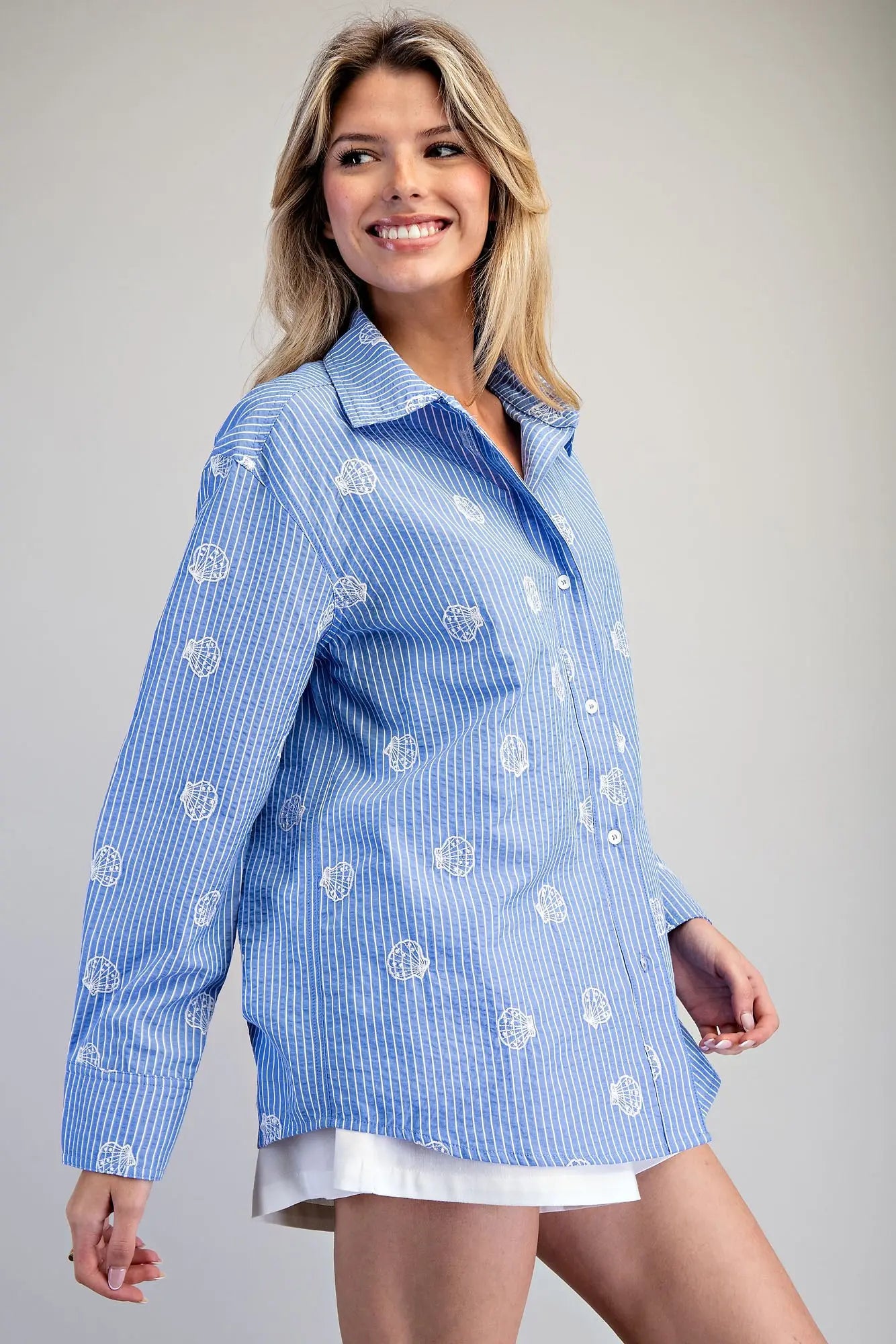 Blue and white striped button down shirt with seashell embroidery