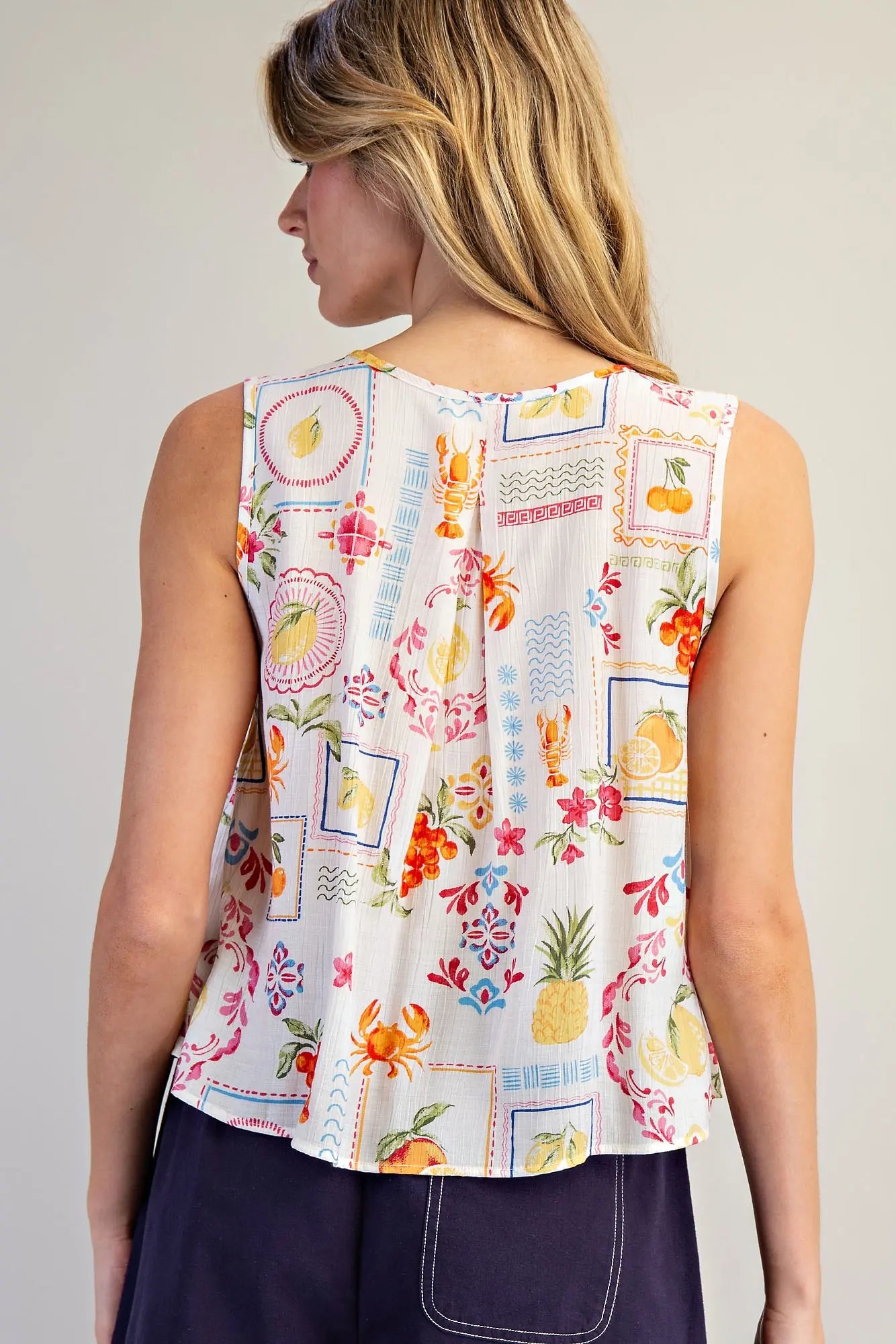 Pleated Blouse features a vibrant fruit and floral patchwork print with soft pleating and a breezy swing
