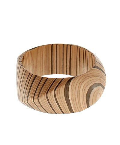 The Eulalia Angled Wood Bangle showcases natural grain with a modern sculpted twist.