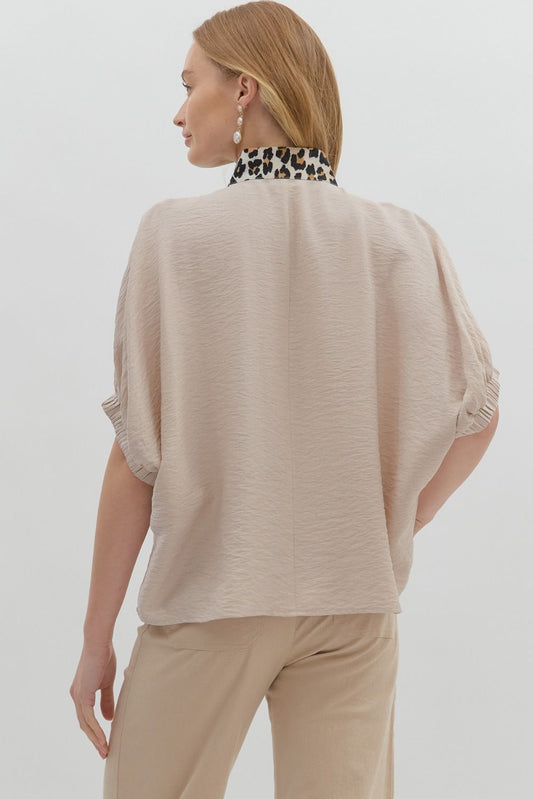 A breezy dolman top with leopard print accents and a caftan-inspired neckline.