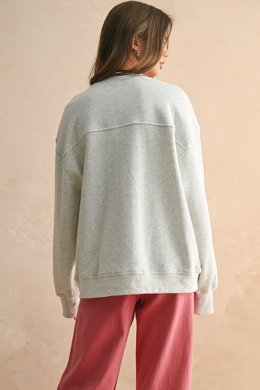 A charming cotton sweatshirt featuring “Bonjour” embroidery for a touch of Parisian flair.