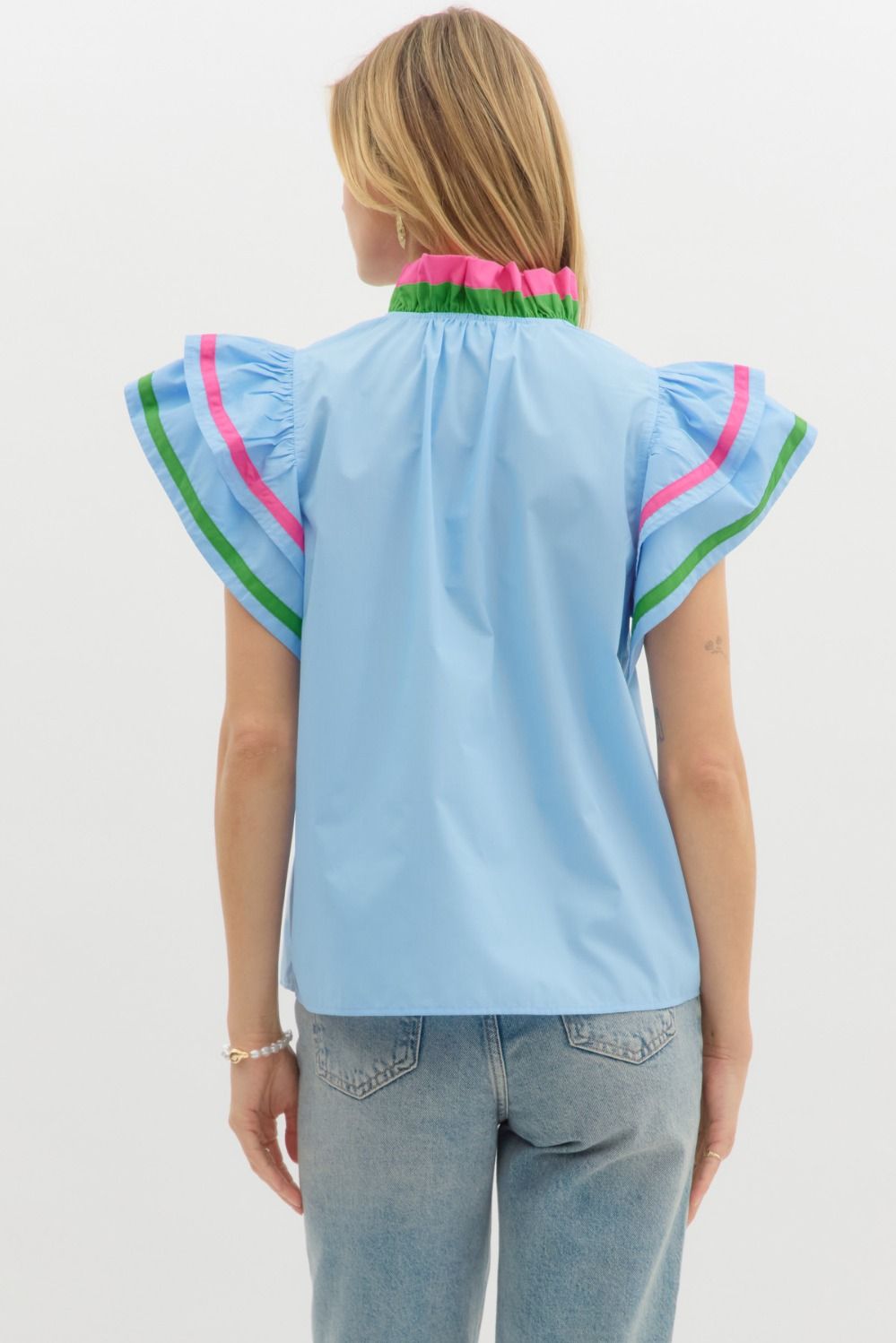 A charming flutter sleeve top with multicolor ruffle accents that add a playful, polished touch.