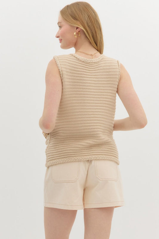 A classic knit vest top with front buttons and pockets for effortless layering and timeless style.