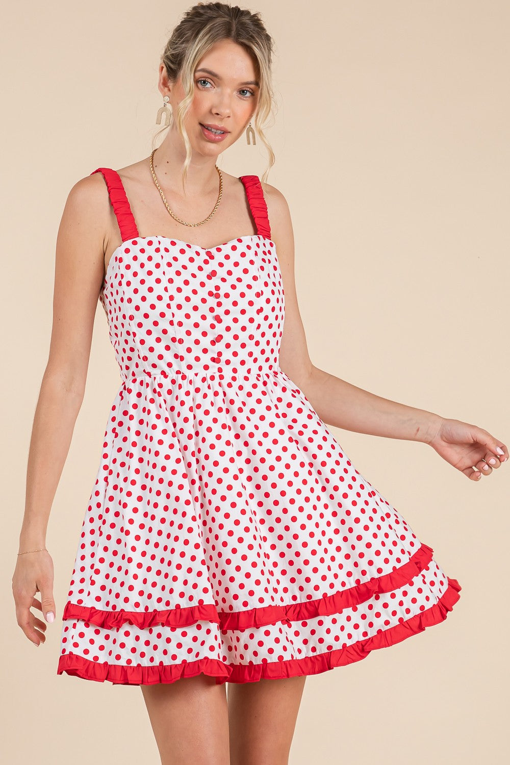 A flirty polka dot bustier-style mini dress with charming details and a flattering fit. 