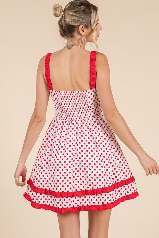 A flirty polka dot bustier-style mini dress with charming details and a flattering fit. 