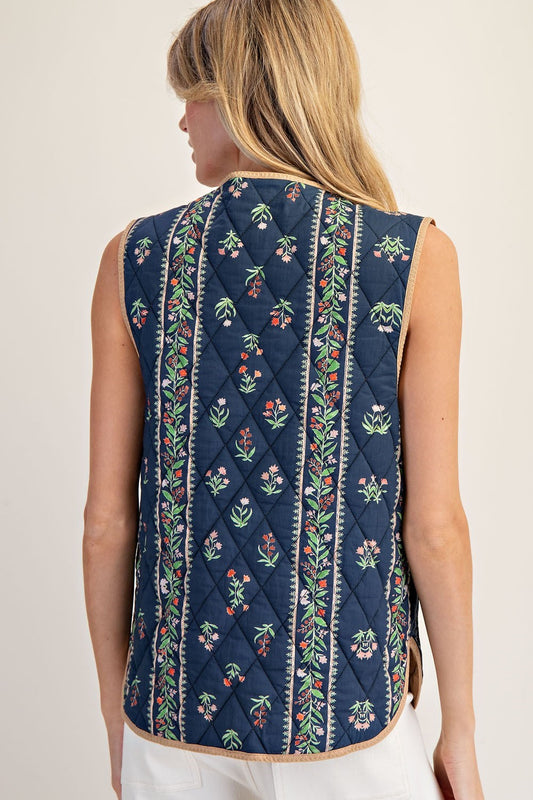 A floral-quilted cotton vest with pink contrast trim and a sweet front-tie finish.
