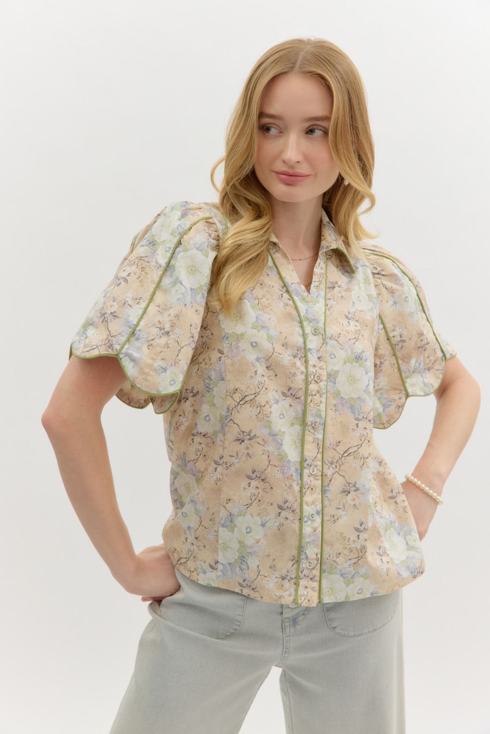 A floral button-front top with puff sleeves, scallop piping, and vintage-inspired charm.
