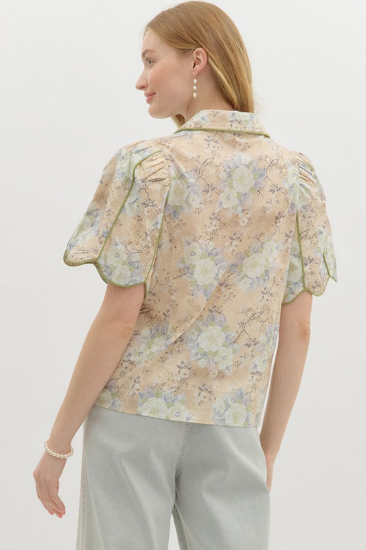A floral button-front top with puff sleeves, scallop piping, and vintage-inspired charm.