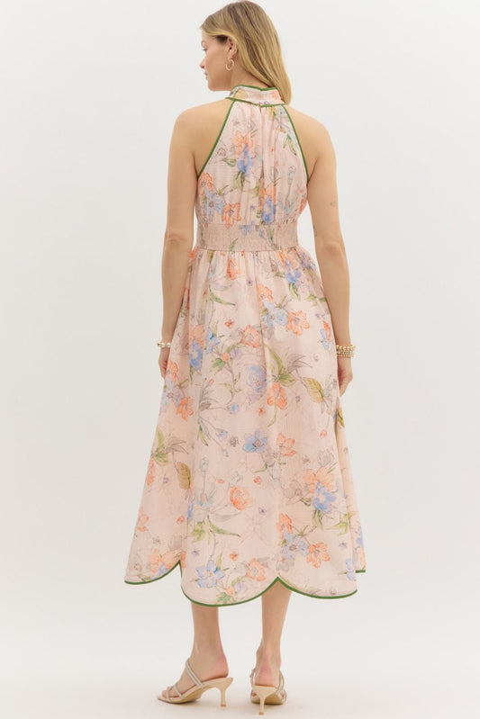 A floral halter midi dress with contrast binding and a flattering smocked waist.