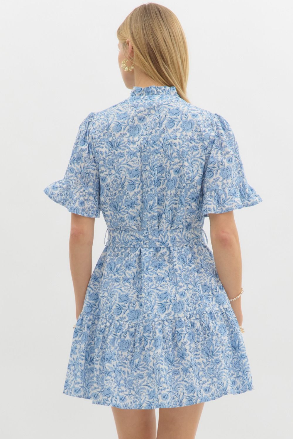 A floral mini dress with ruffle accents and a belted waist for a sweet, feminine silhouette.