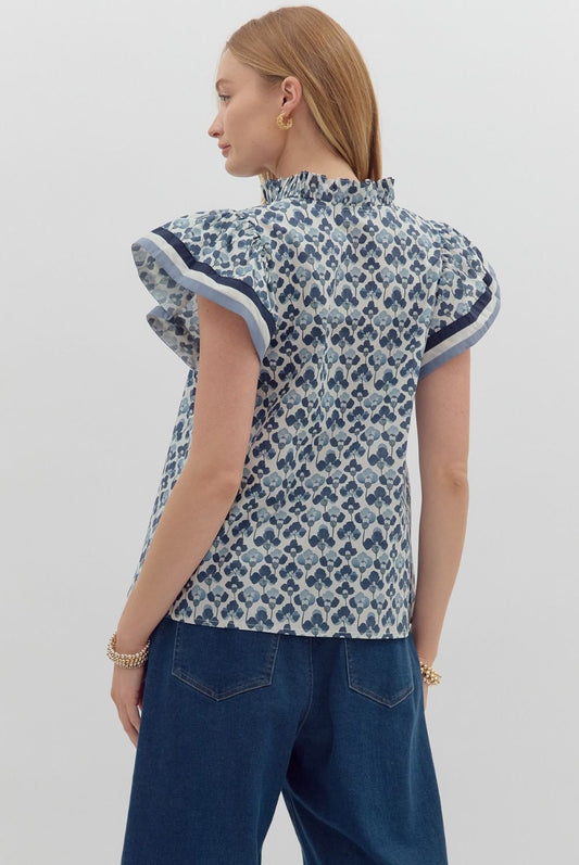 A floral print pullover top with ruffle split V-neck and flutter sleeves with a multicolor hem.