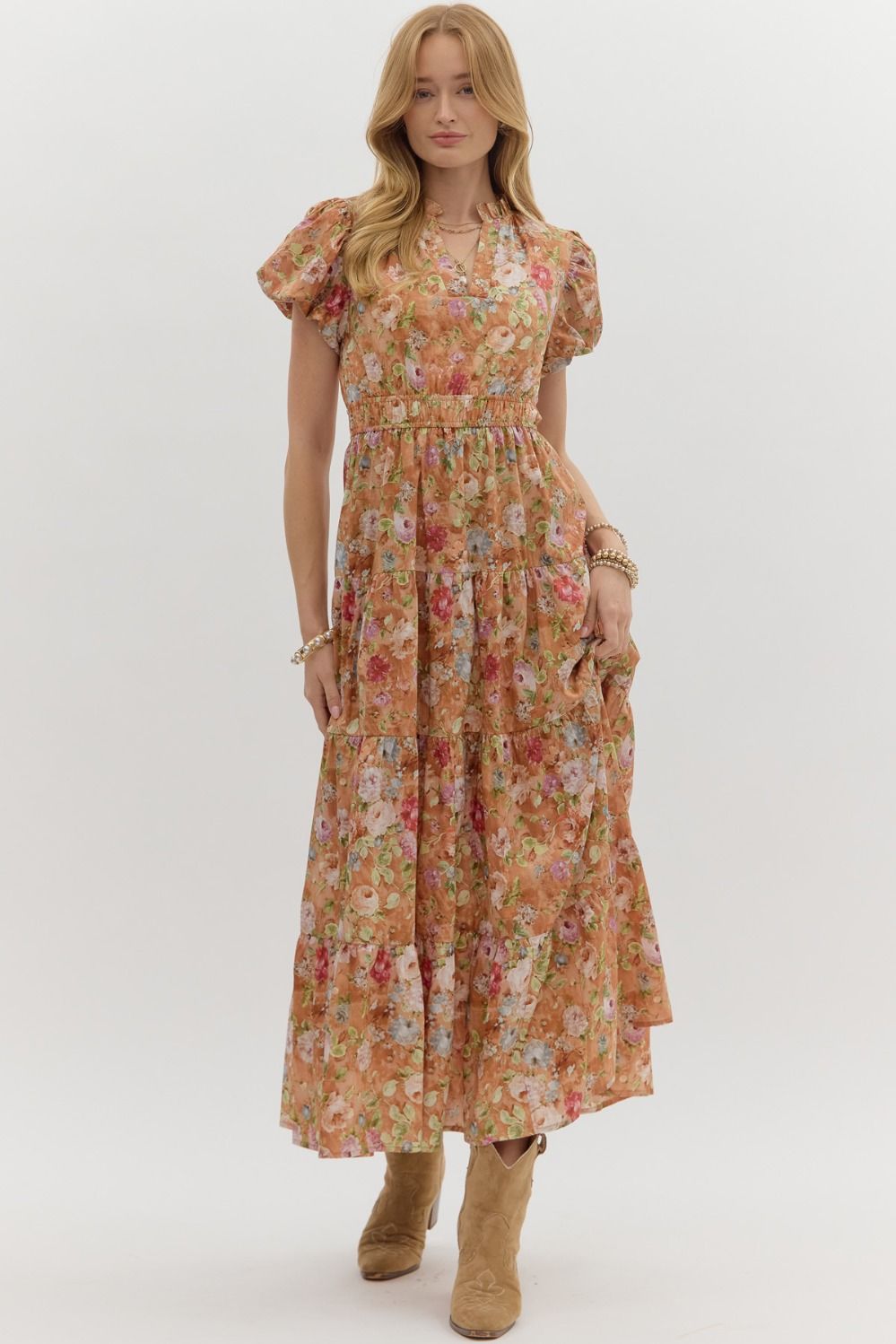 A floral puff sleeve tiered midi dress with an easy pullover fit and double elastic waist.