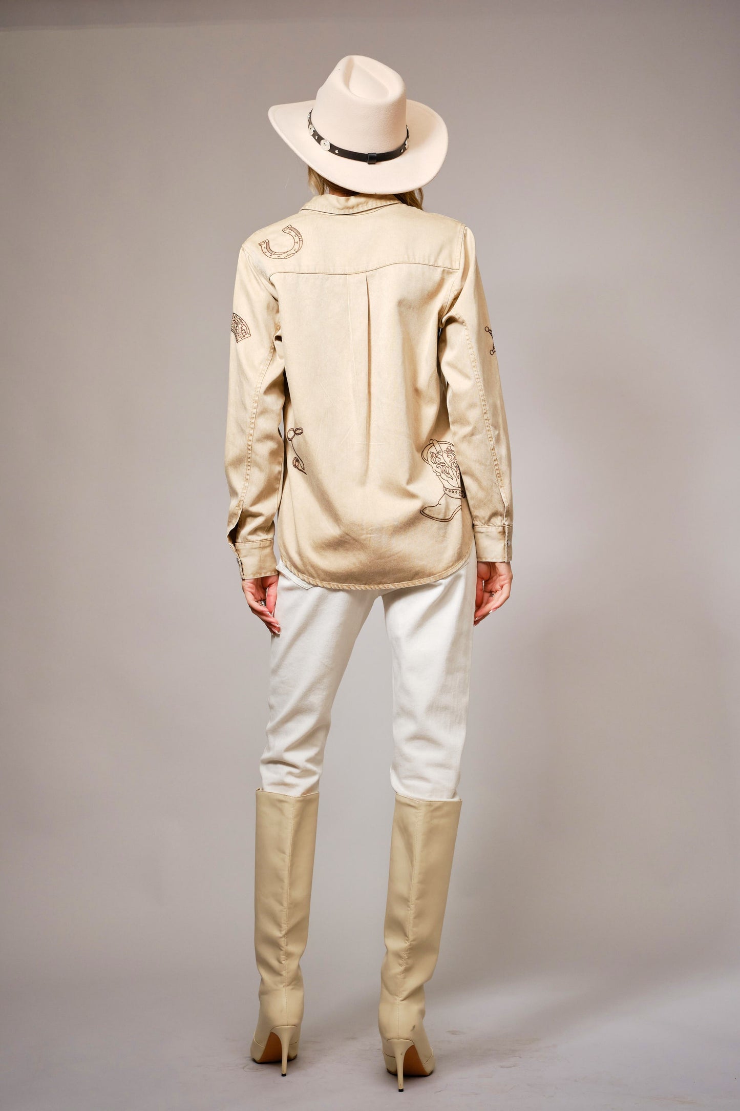 A garment-washed chambray shirt with western embroidery and classic snap buttons.