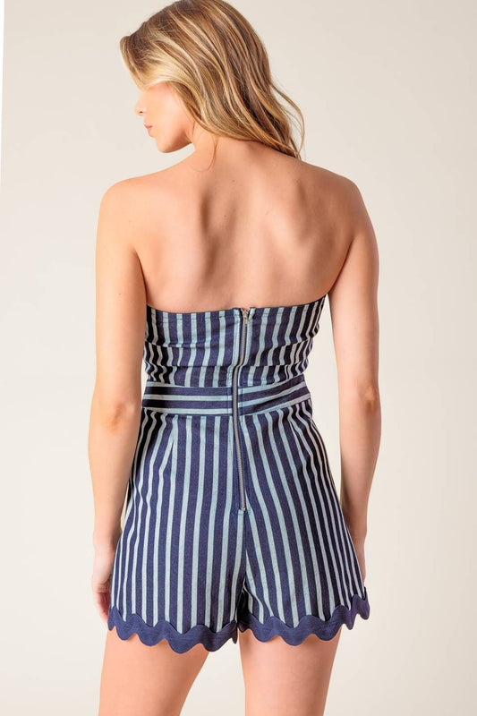 A playful off-shoulder skort romper with ric rac ribbon trim and a flattering fit.