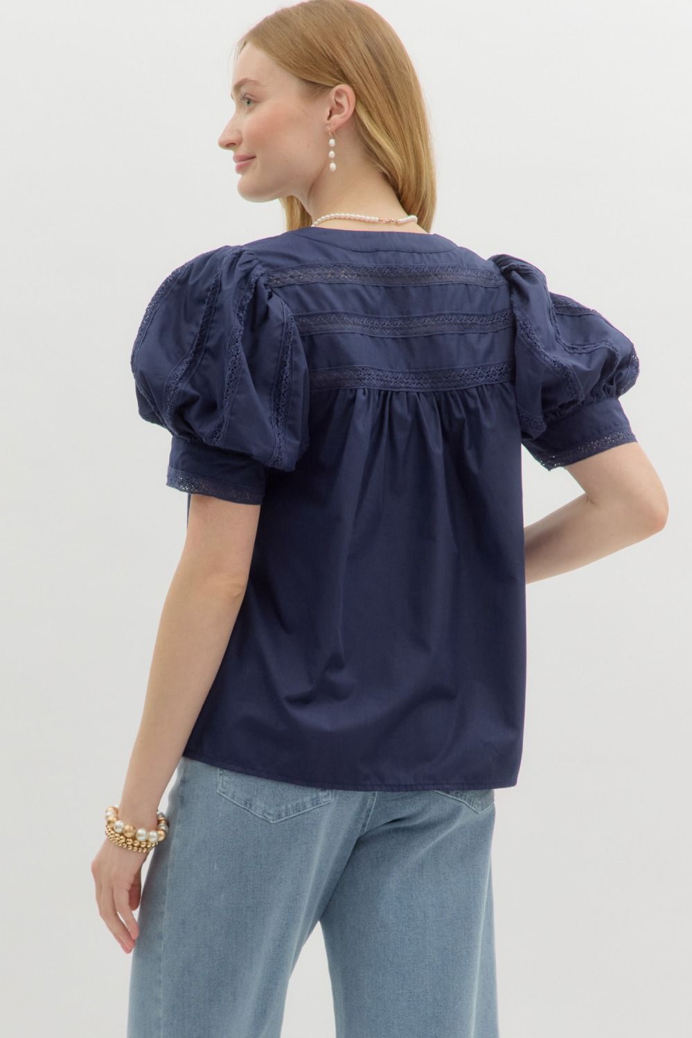 A romantic V-neck puff sleeve top with delicate lace insets and a soft, lightweight feel.