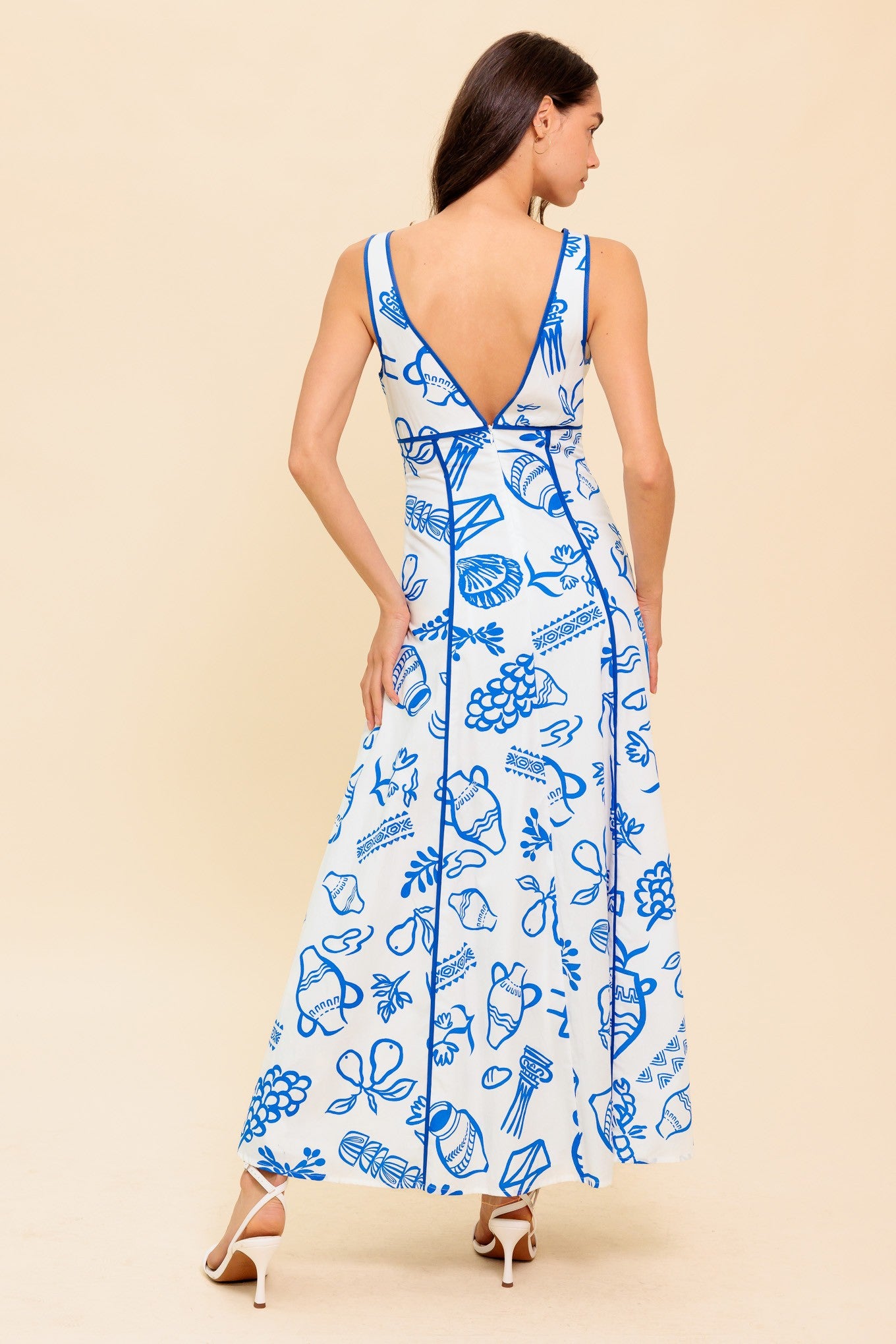 A romantic ankle-length printed dress with a bow-tied V neckline and plunging back for effortless elegance.