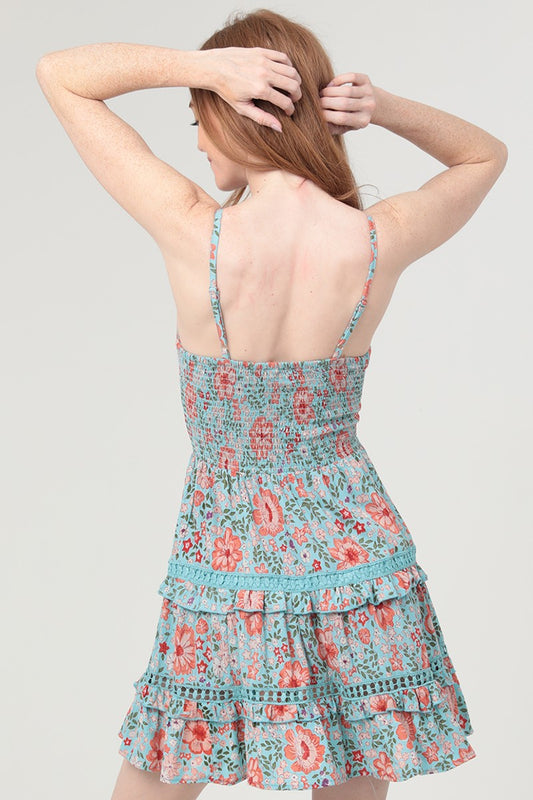 A romantic twist-front cut-out dress featuring delicate lace inserts and a deep V neckline.