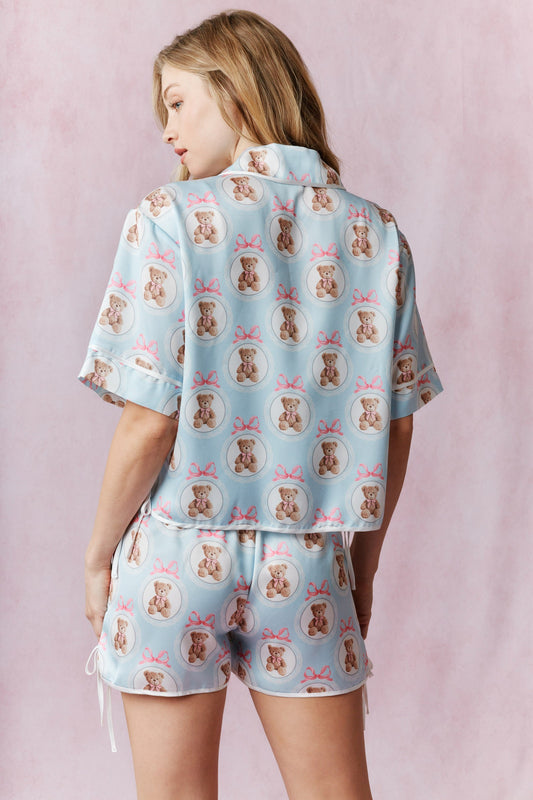 A silky satin pajama set featuring charming teddy bear and bow prints.