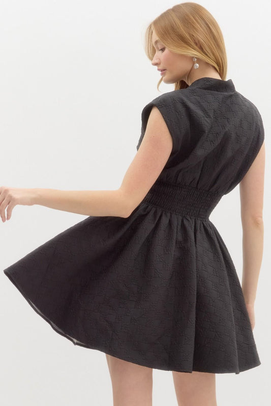 A sophisticated sleeveless mini dress with a floral diamond pattern, smocked waist, and functional side pockets for effortless elegance.