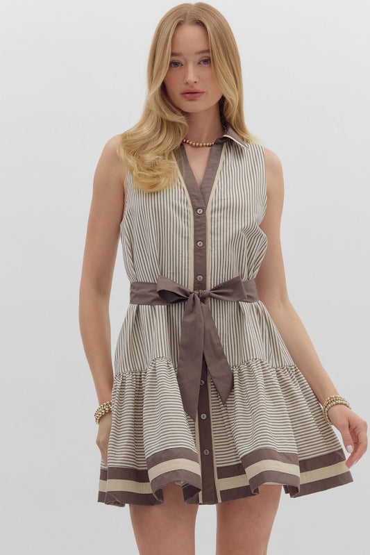 A striped sleeveless mini dress with ruffle hem, multicolor band detailing, and a removable belt.