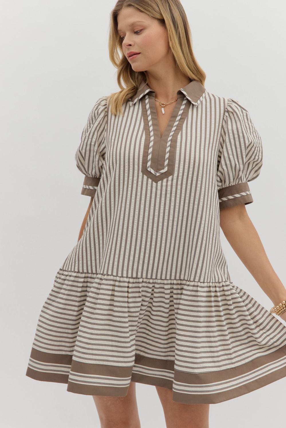 A textured stripe puff sleeve mini dress with a contrasting spread collar and handy side pockets.
