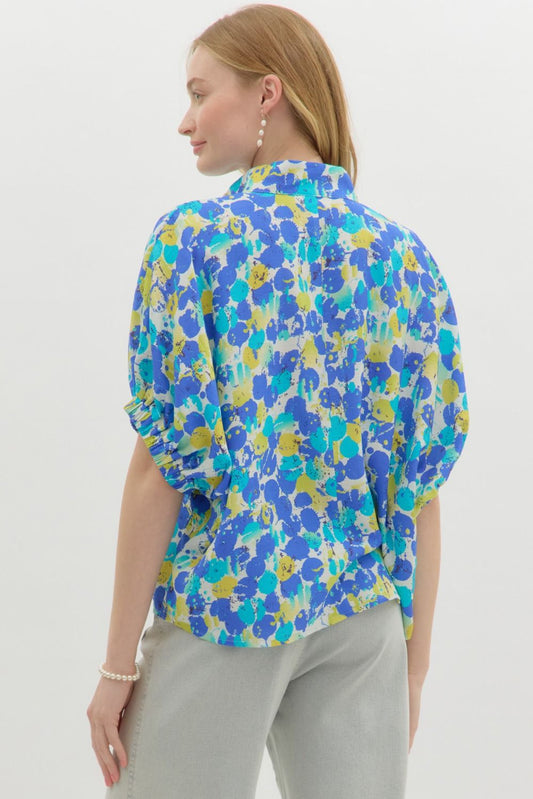 A vibrant, easygoing top with dolman sleeves and a colorful abstract print.