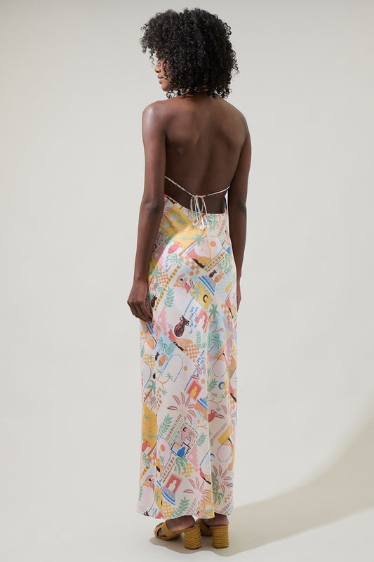 A vibrant halter midi dress with an open back and dreamy sunset-inspired print.
