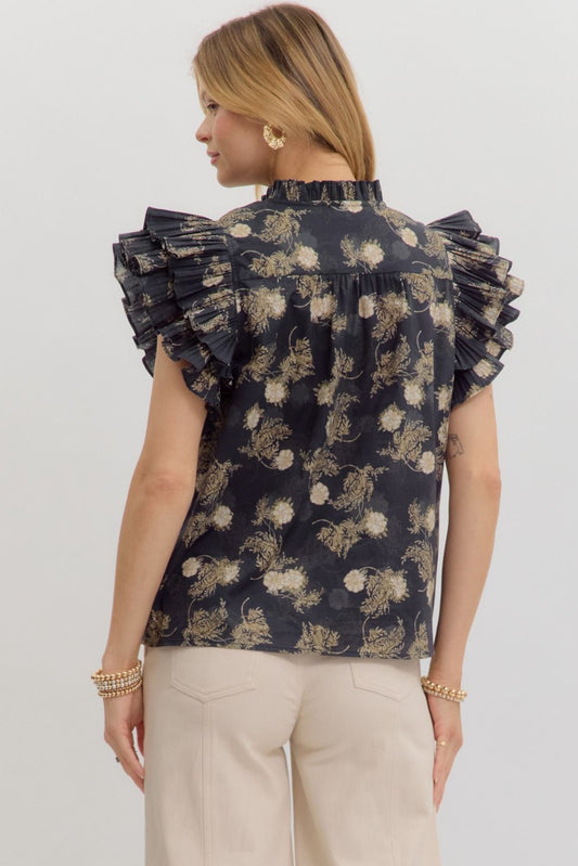 A vintage floral top with pleated ruffle sleeves and a soft, romantic silhouette.