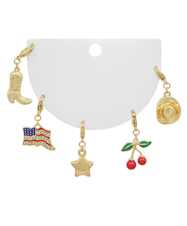 Set of five gold-toned clip-on charms featuring a cowboy boot, an American flag with rhinestones, a star, cherries with green leaves, and a cowboy hat.